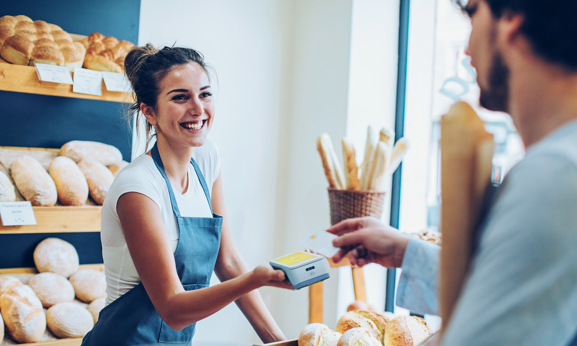 Woman in bakery receives payment